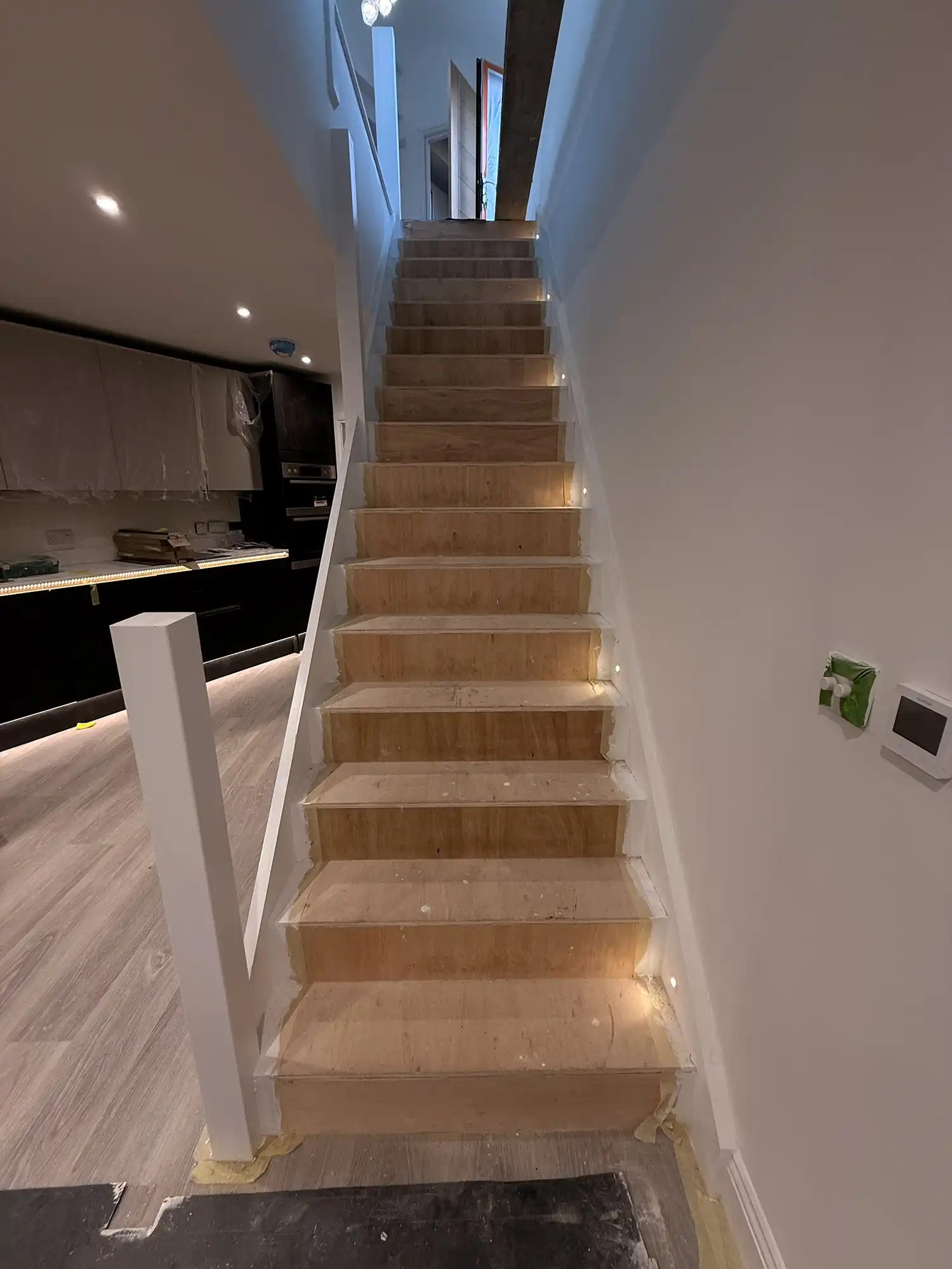 A set of stairs leading up to a kitchen.