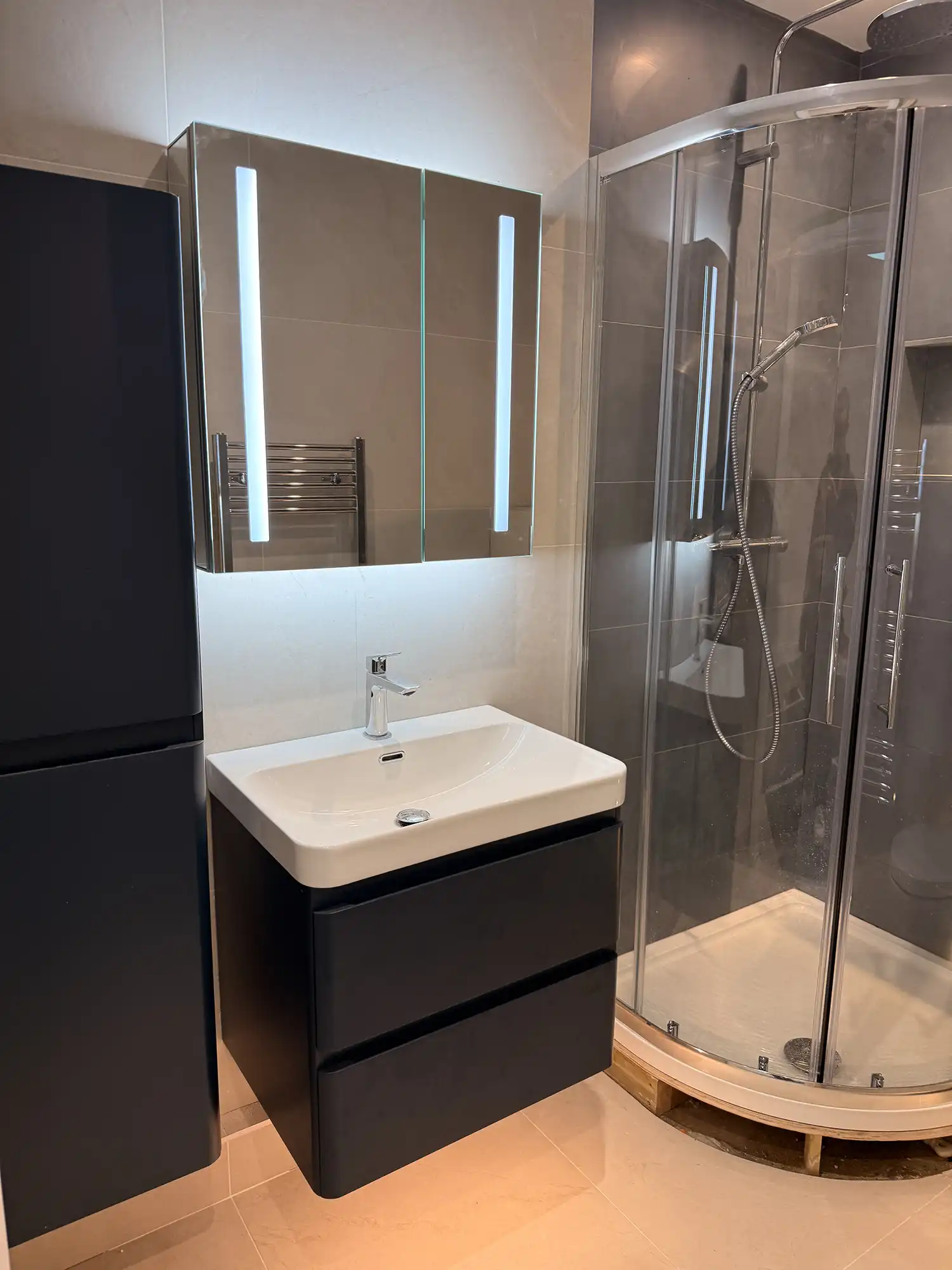 A bathroom with a sink and a shower.