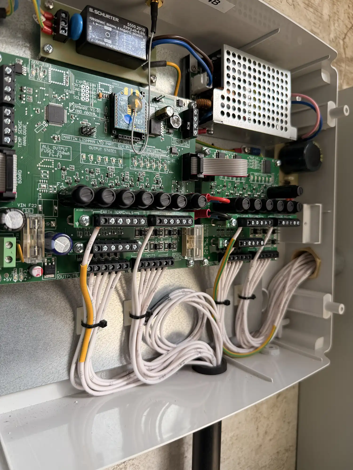 A close up of a circuit board with wires.