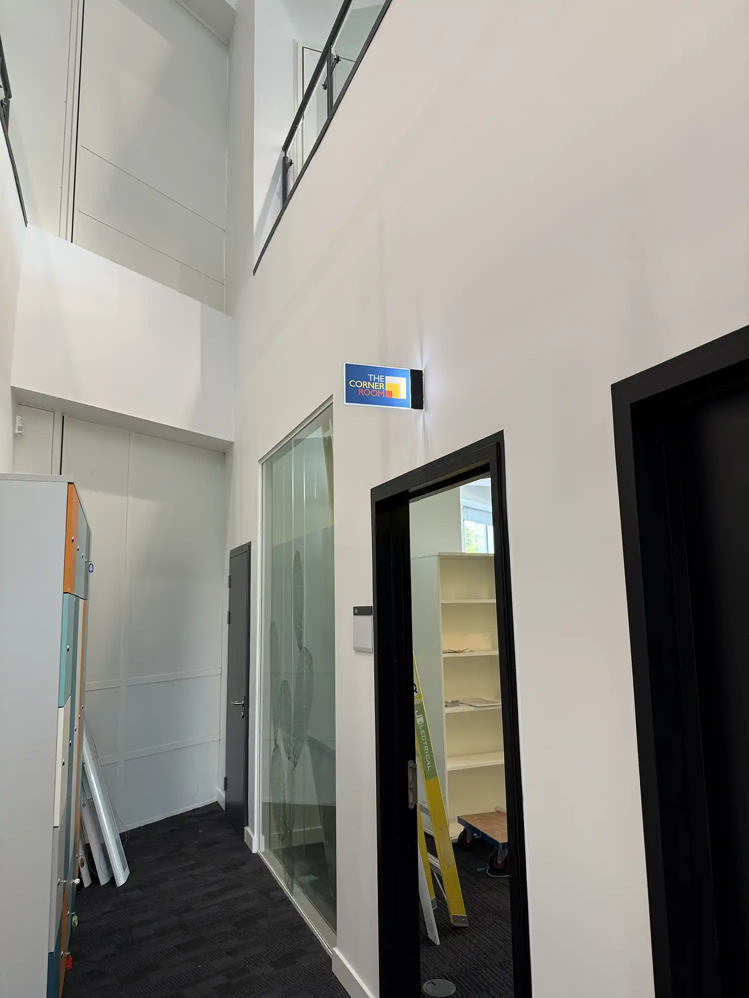 A room with a mirror and a shelf in it.