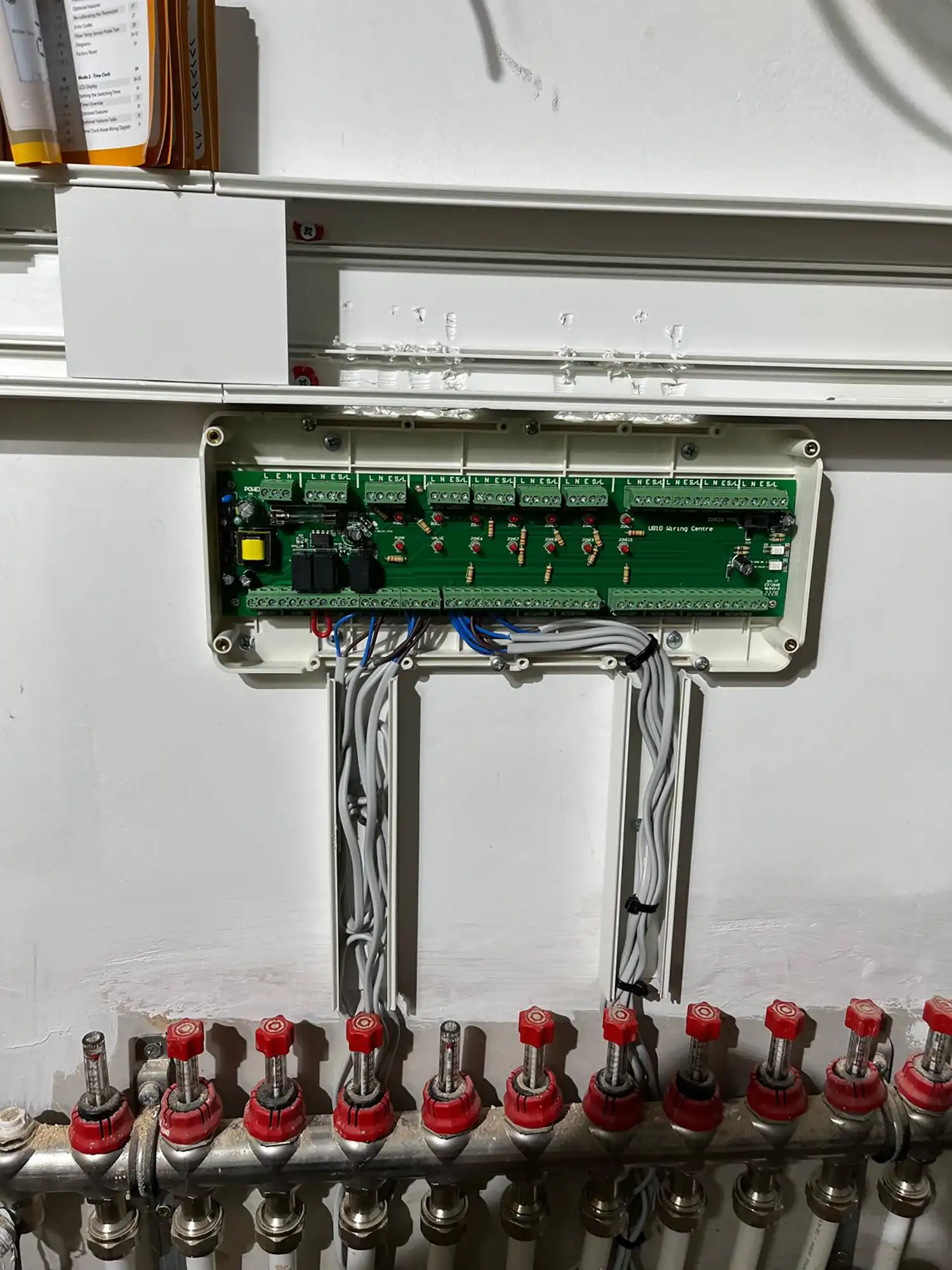 A close up of a control panel with red knobs.