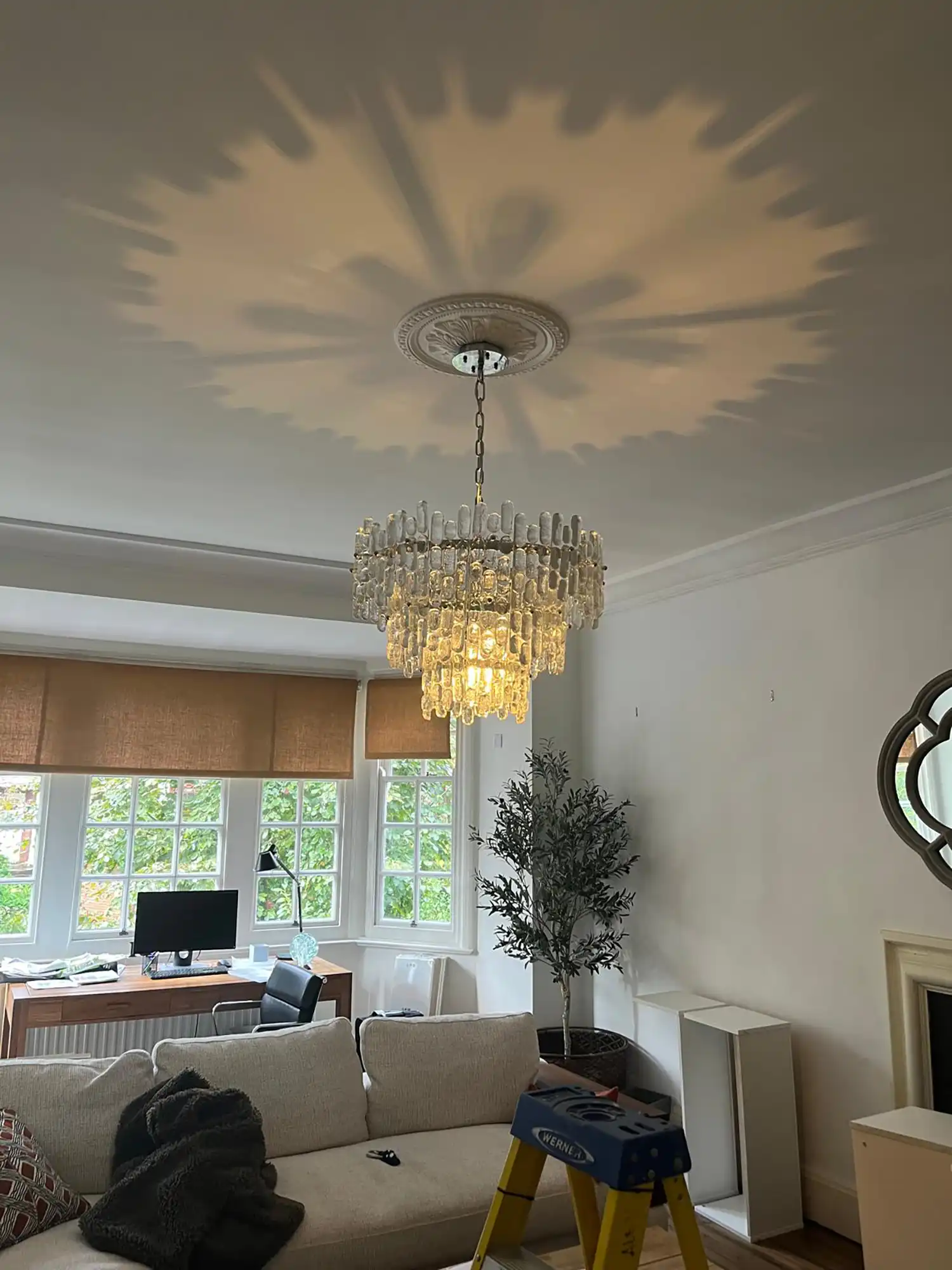 A living room filled with furniture and a chandelier.