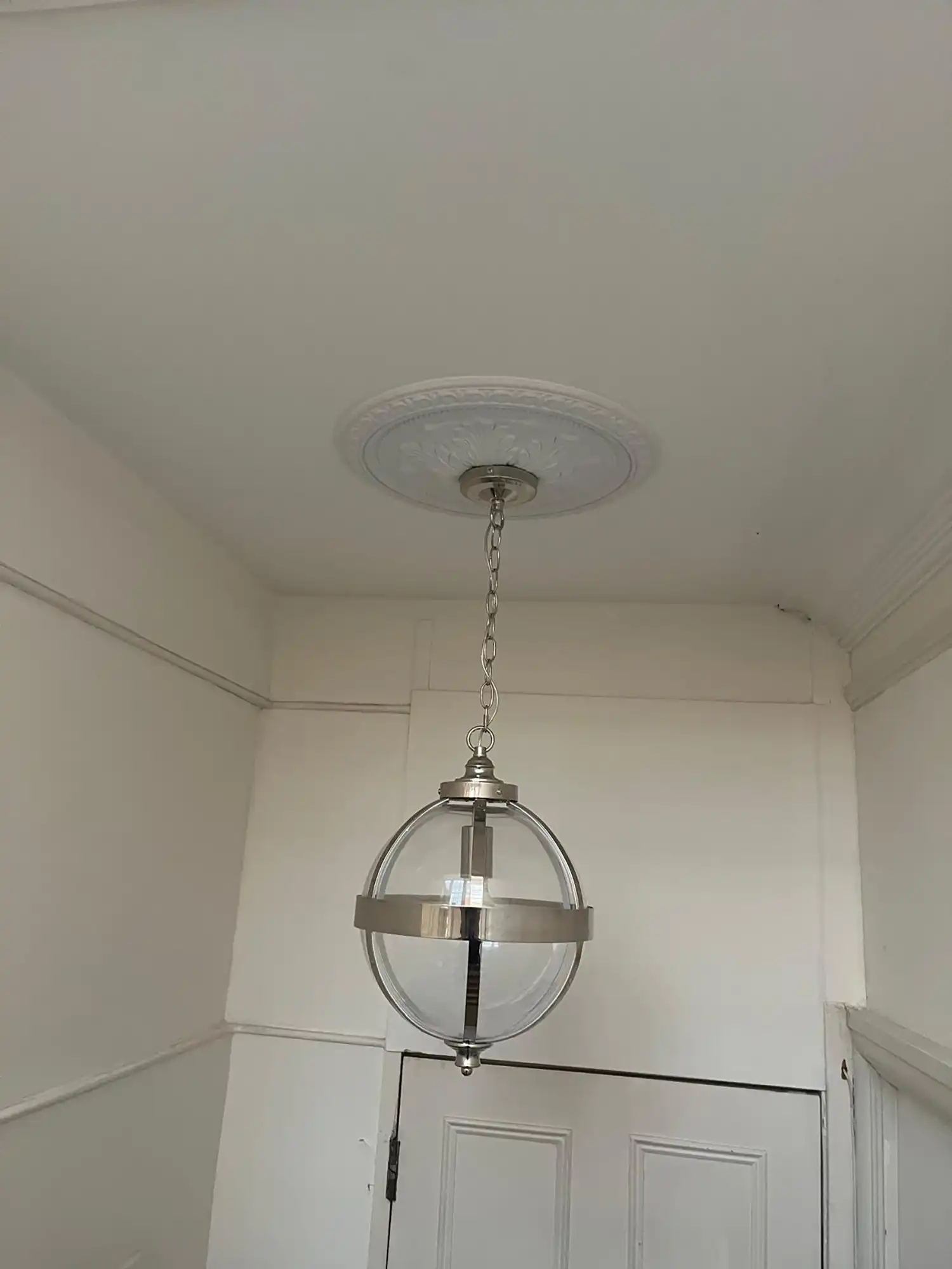 A light hanging from a ceiling in a room.